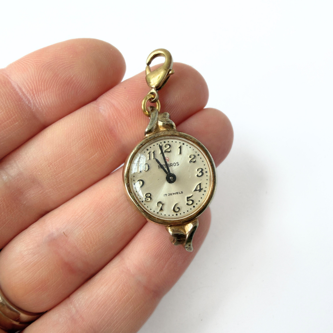Vintage gold plated "Hilbros" circular watch face charm