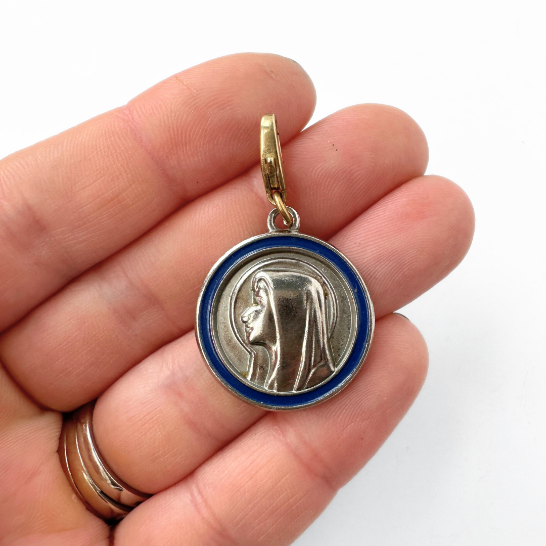Vintage silver tone Our Lady of Lourdes circular charm with blue enamel