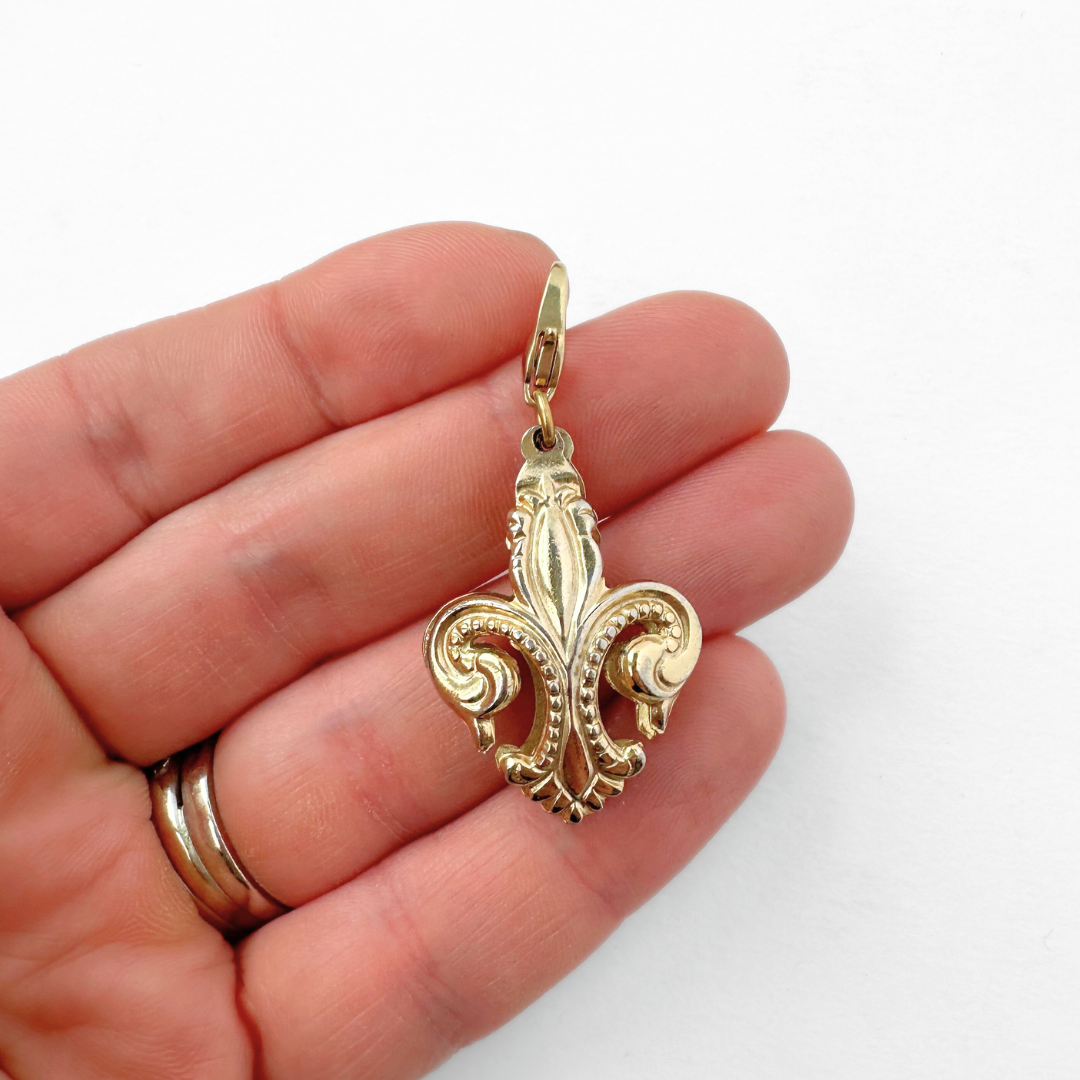 Vintage muted gold puffy fleur de lis charm