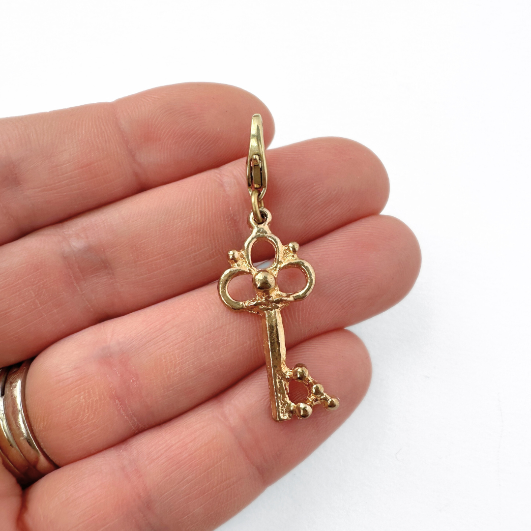 Small vintage gold tone skeleton key charm pendant