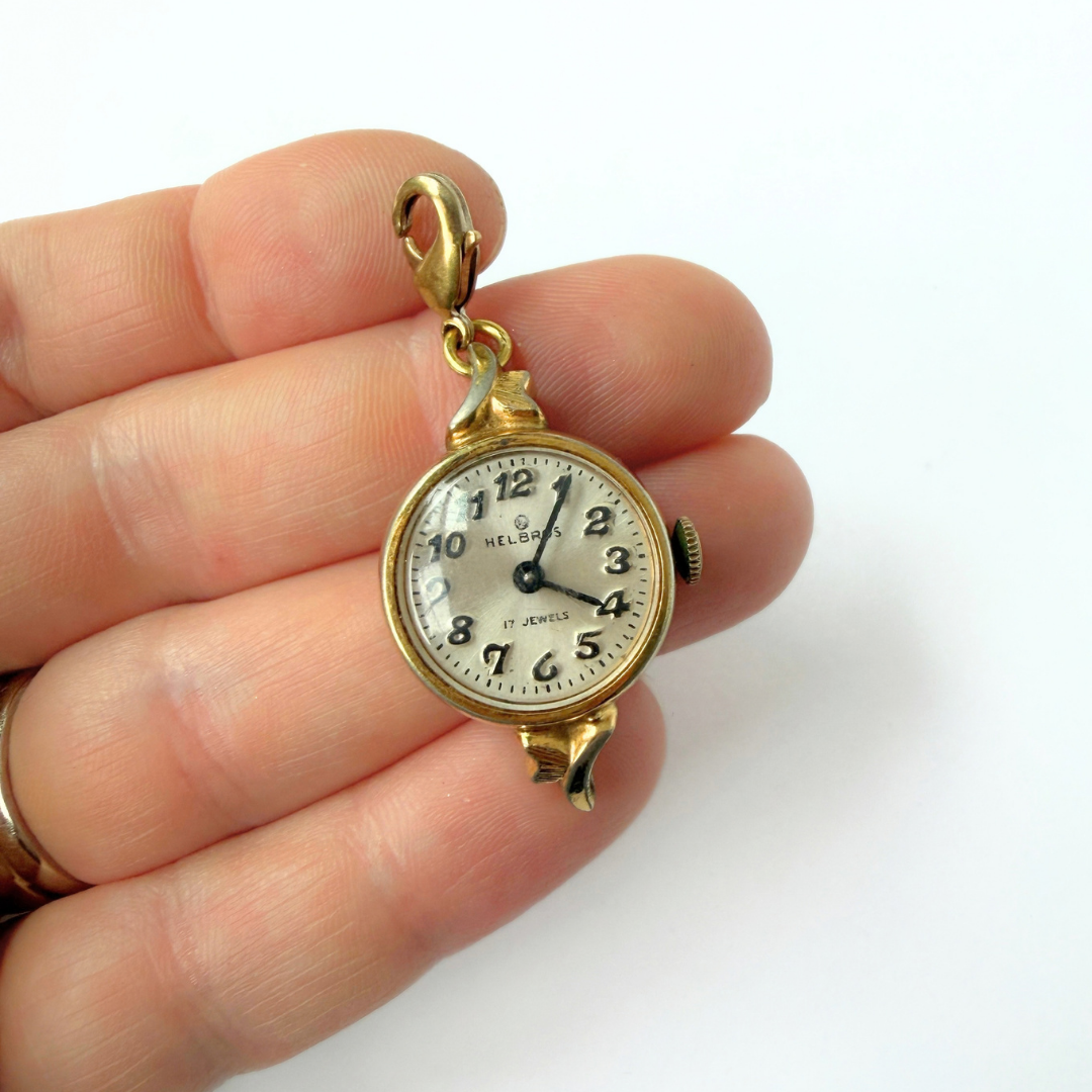 Vintage gold plated "Hilbros" circular watch face charm