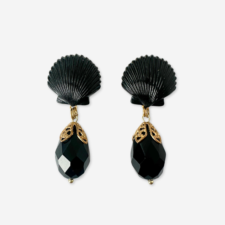 Black shell-shaped earrings with gold accents on a white background