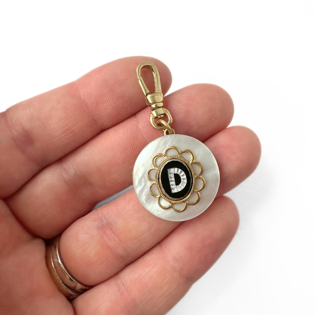 Vintage mother of pearl circular charm with black glass "D" monogram