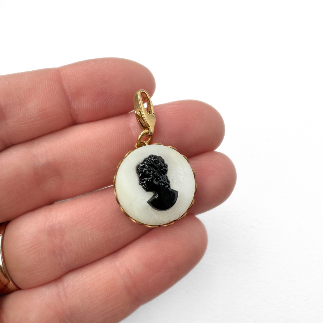Circular black and white vintage cameo charm