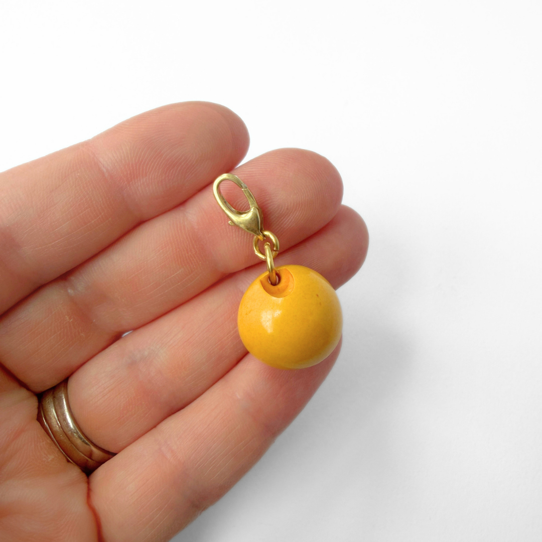 Vintage mustard yellow bakelite bead charm