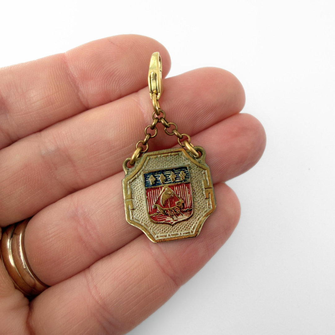 Vintage aged brass Parisian medal charm: Coat of Arms
