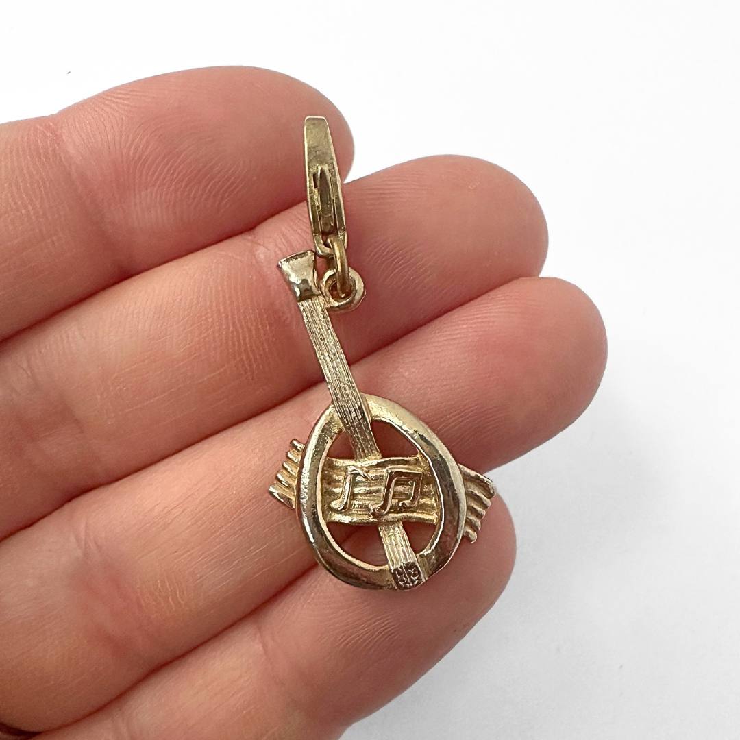 Vintage muted gold lute and music staff charm