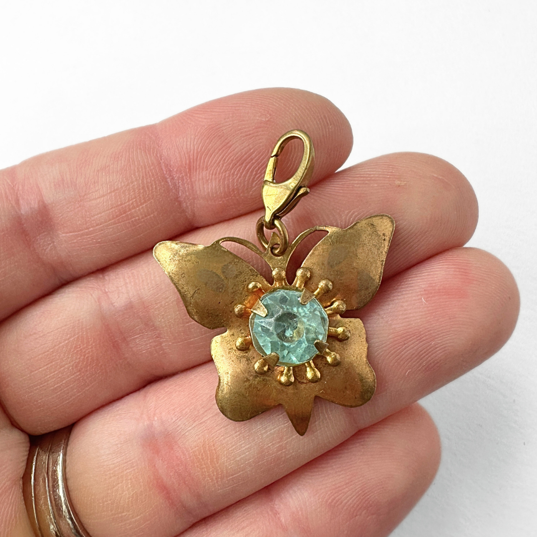 Vintage aged brass butterfly charm with aqua rhinestone