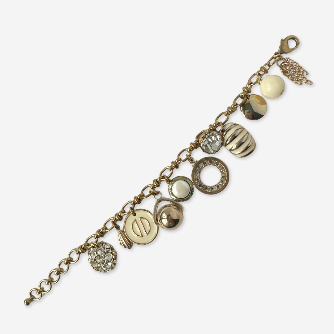 Repurposed vintage cream and gold mixed charm bracelet