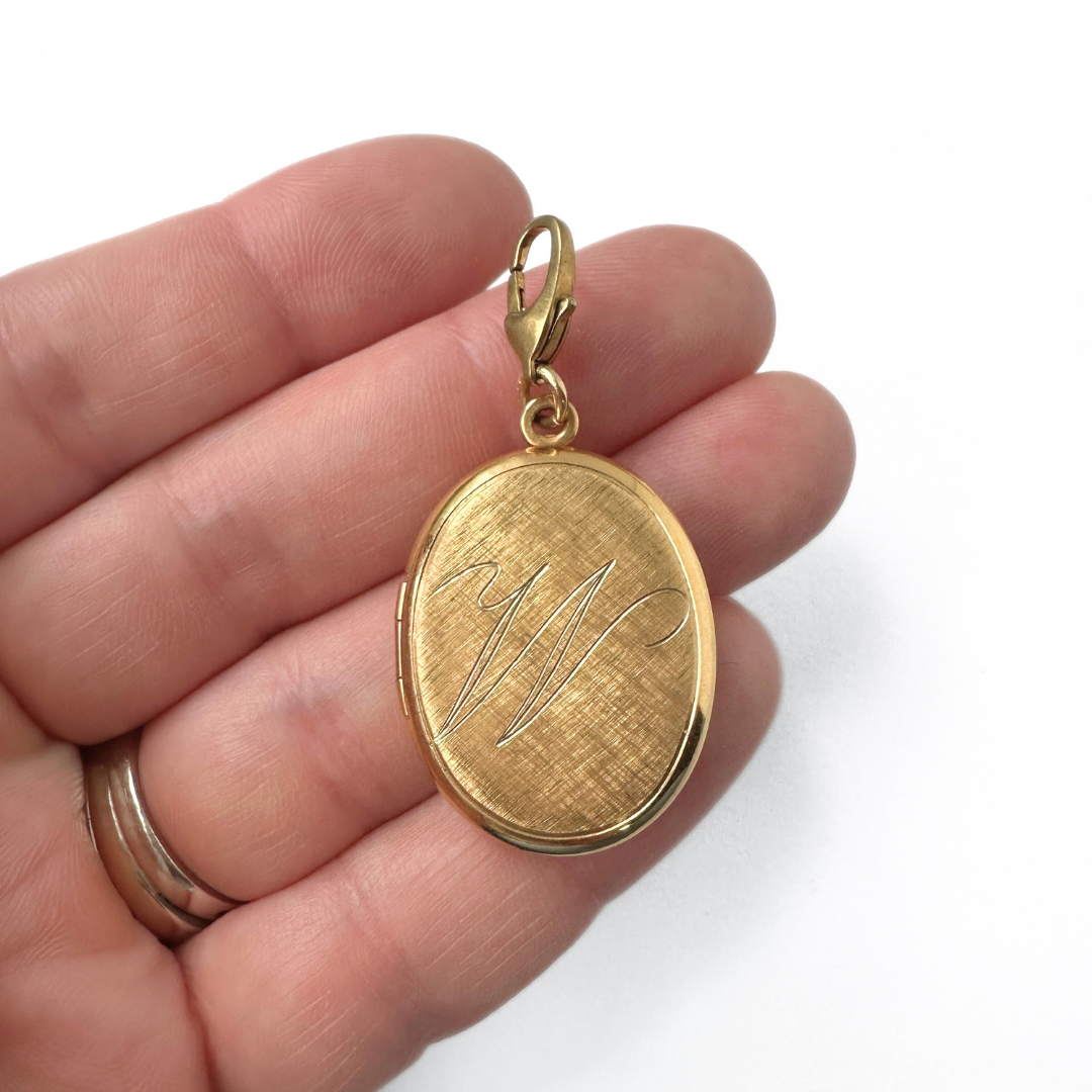 Vintage gold tone oval locket with cursive "W" engraving