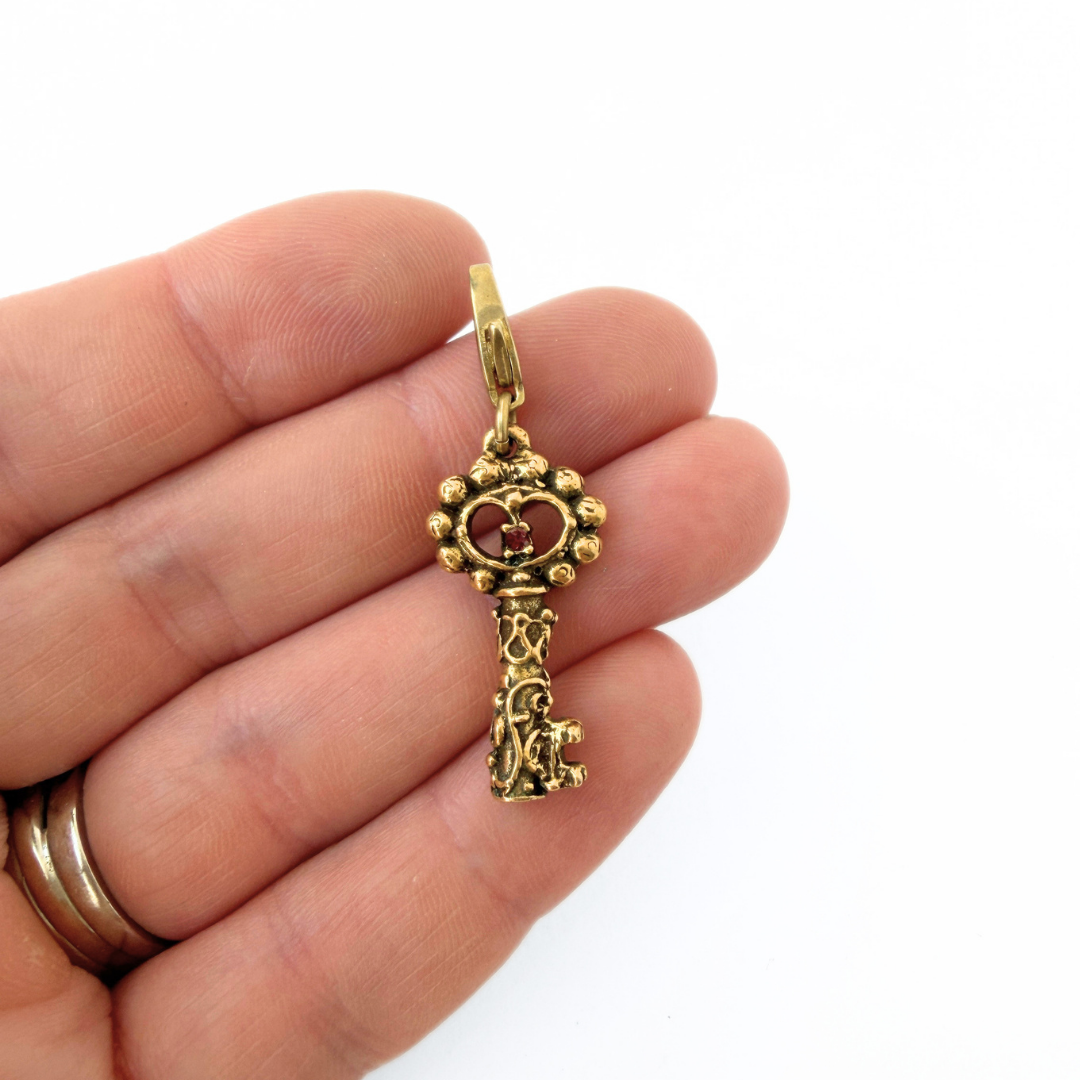 Vintage antique gold tone ornate key charm
