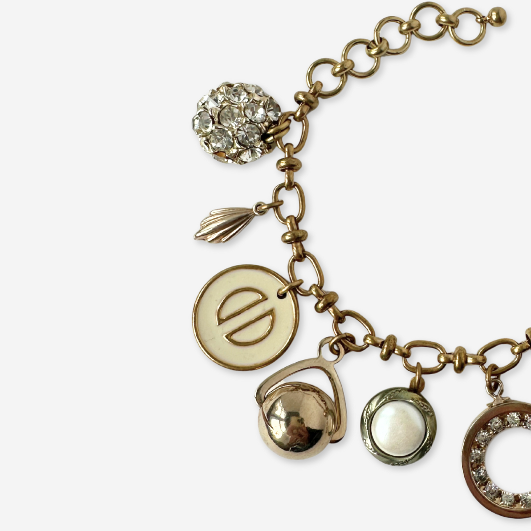 Repurposed vintage cream and gold mixed charm bracelet