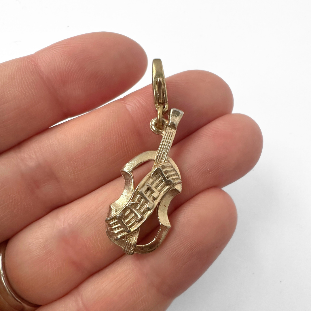 Vintage muted gold violin and music staff charm