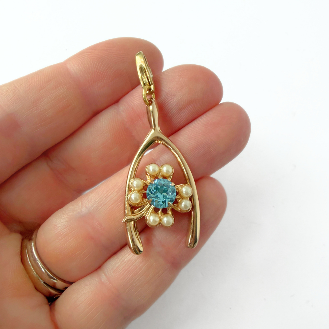 Vintage large gold tone wishbone charm with aqua clover center