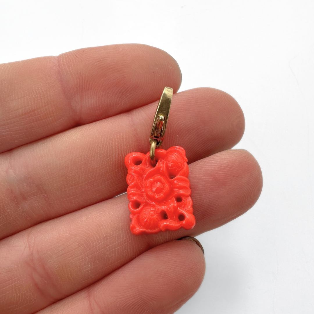 Small vintage coral pierced glass floral charm