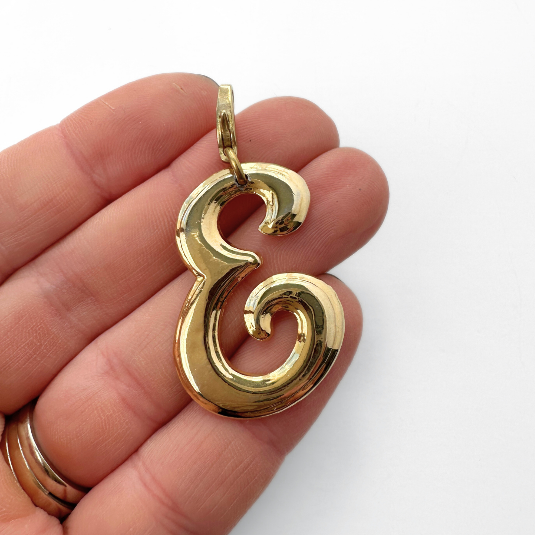 Large vintage shiny gold cursive "E" charm