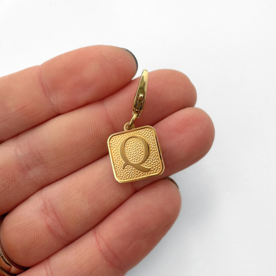 Small vintage gold square "Q"monogram charm