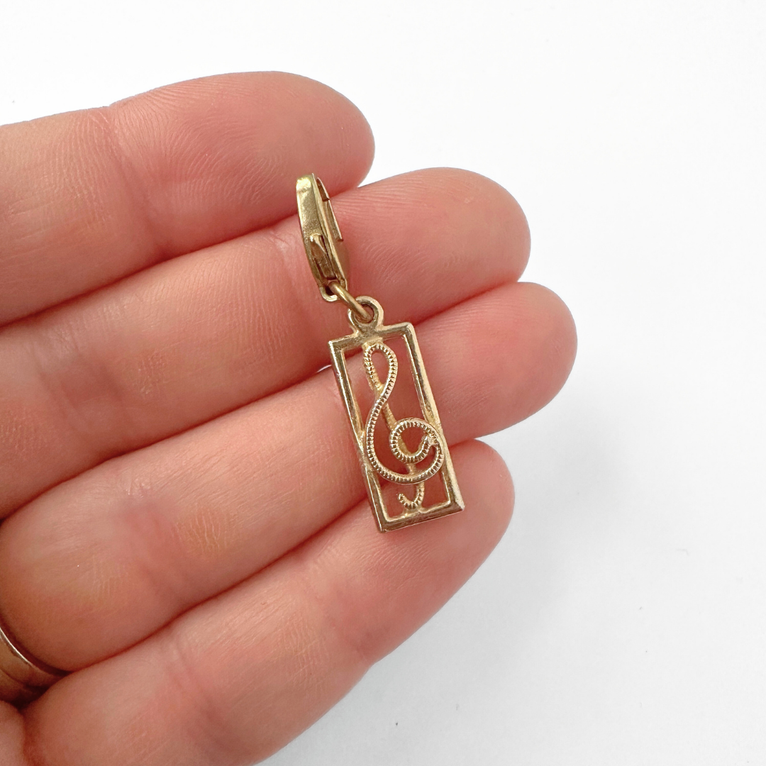 Vintage muted gold rectangular treble clef charm