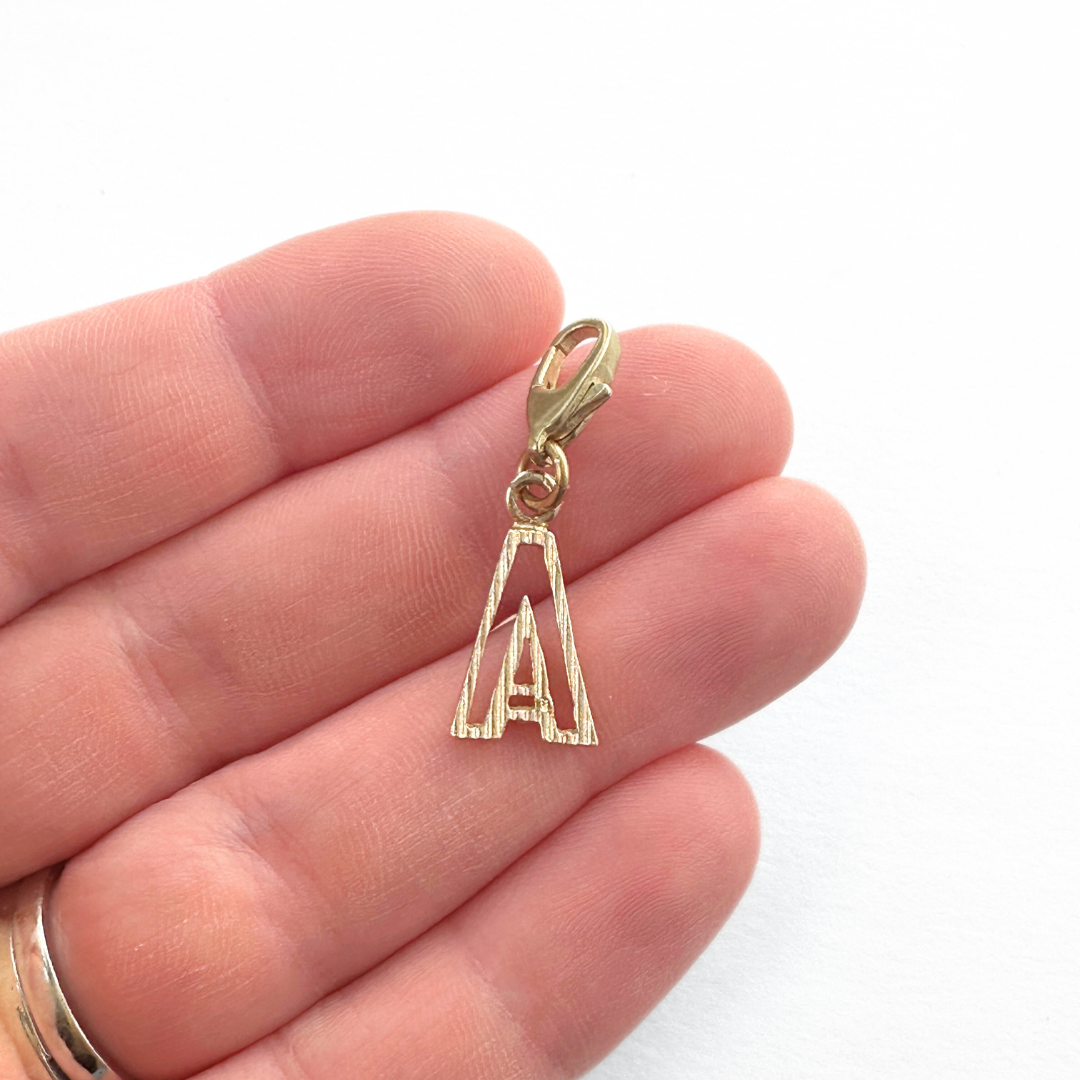Small vintage gold tone cutout "A" monogram charm