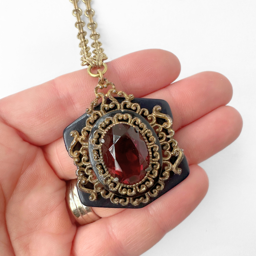 Repurposed ruby red ornate oval pendant on navy acrylic base