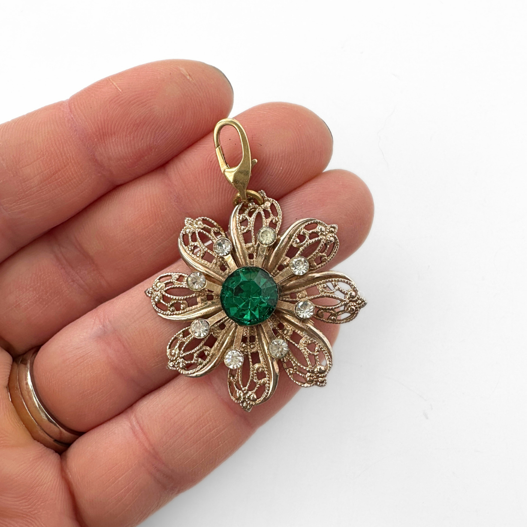 Vintage large brass filigree flower charm with green rhinestone center