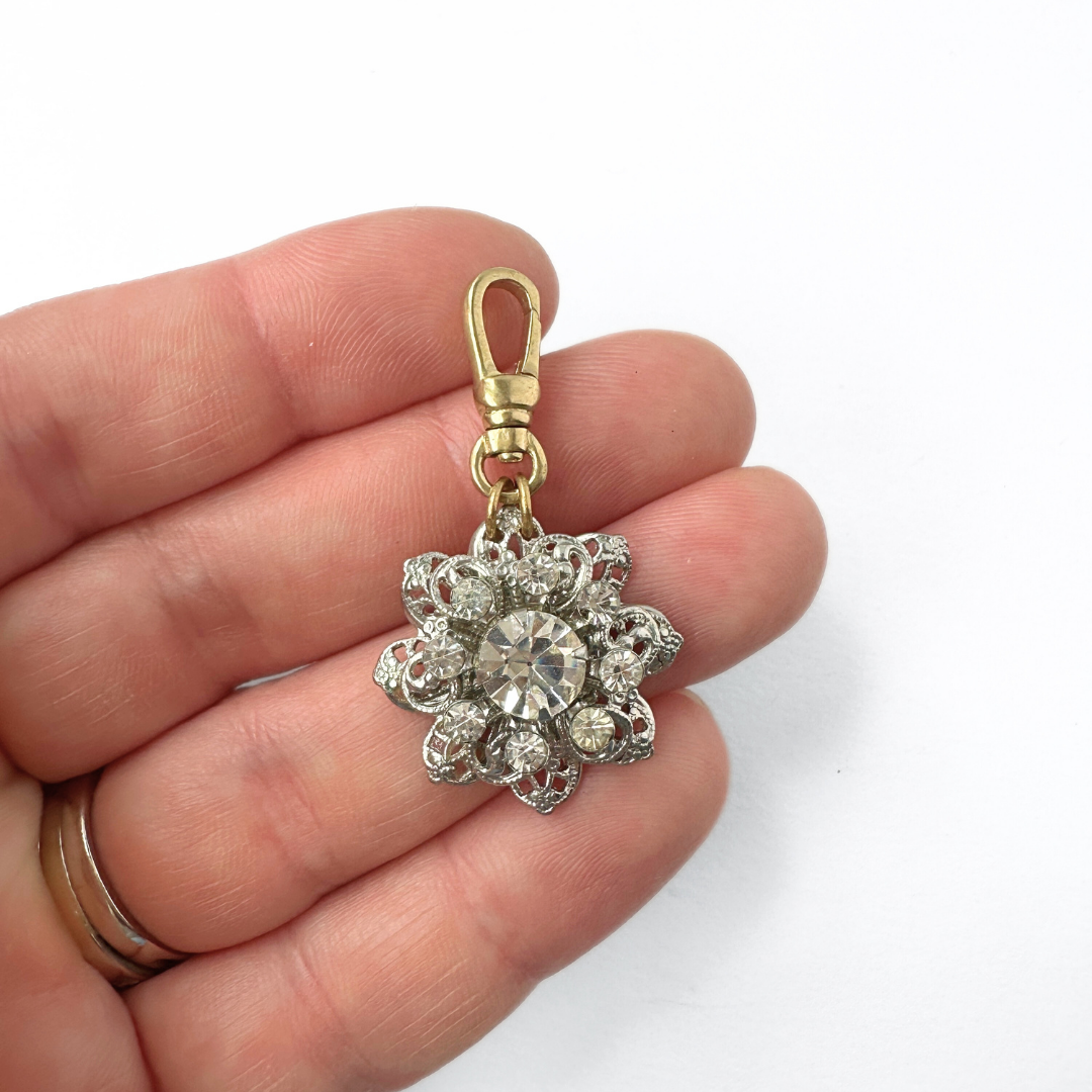 Vintage clear rhinestone and silver filigree flower charm
