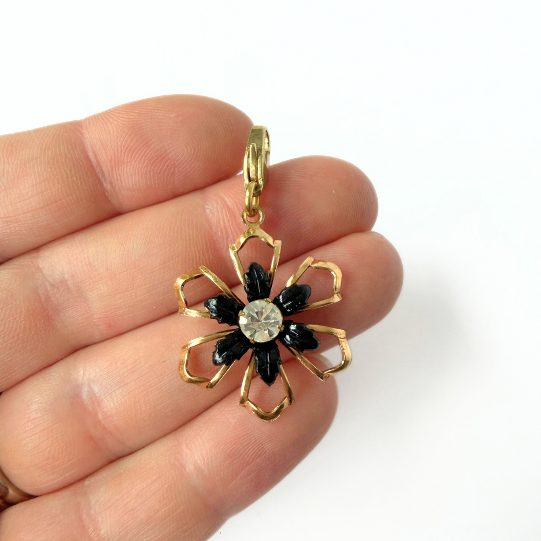 Vintage black and gold open flower charm with rhinestone center