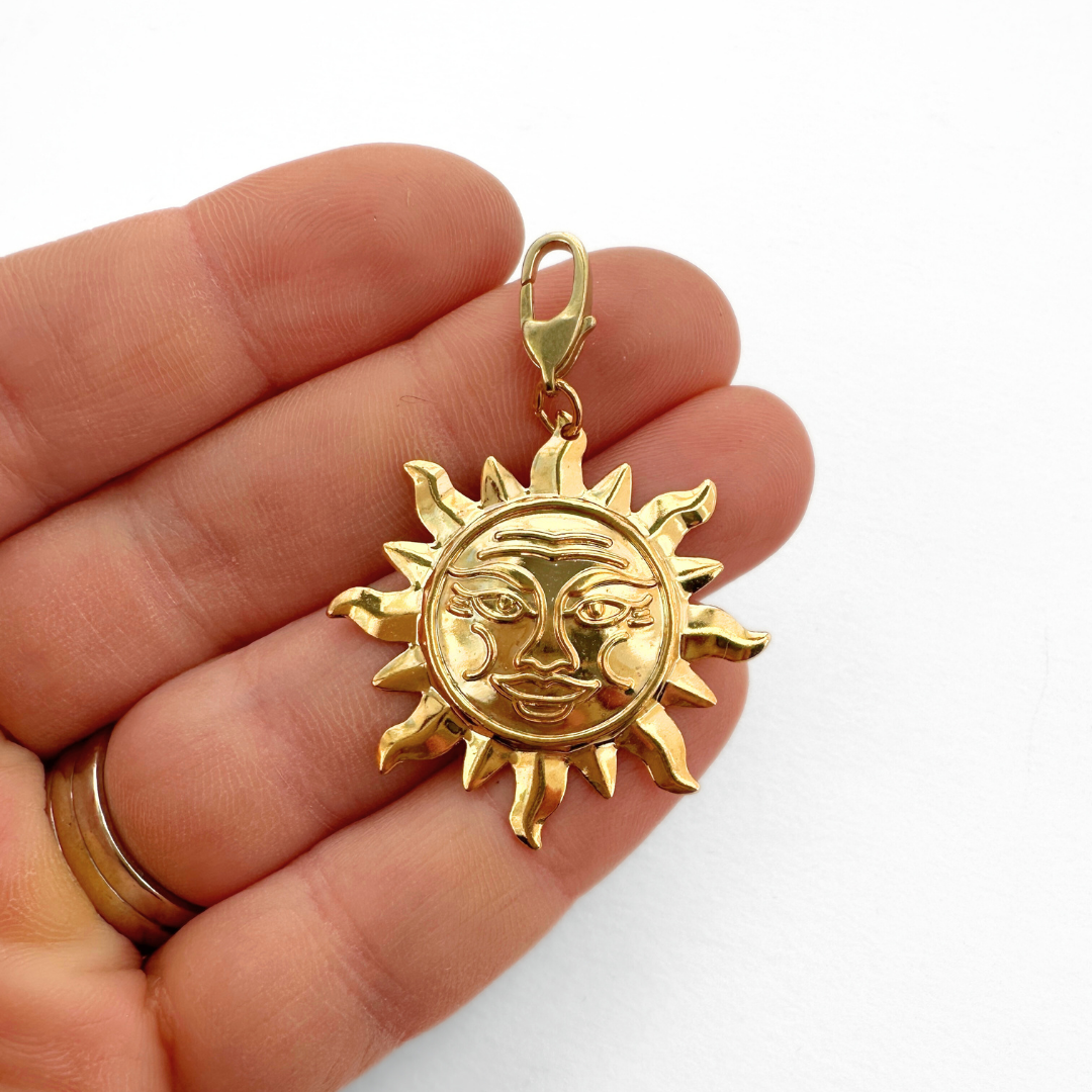 Vintage gold plated stamped sun charm