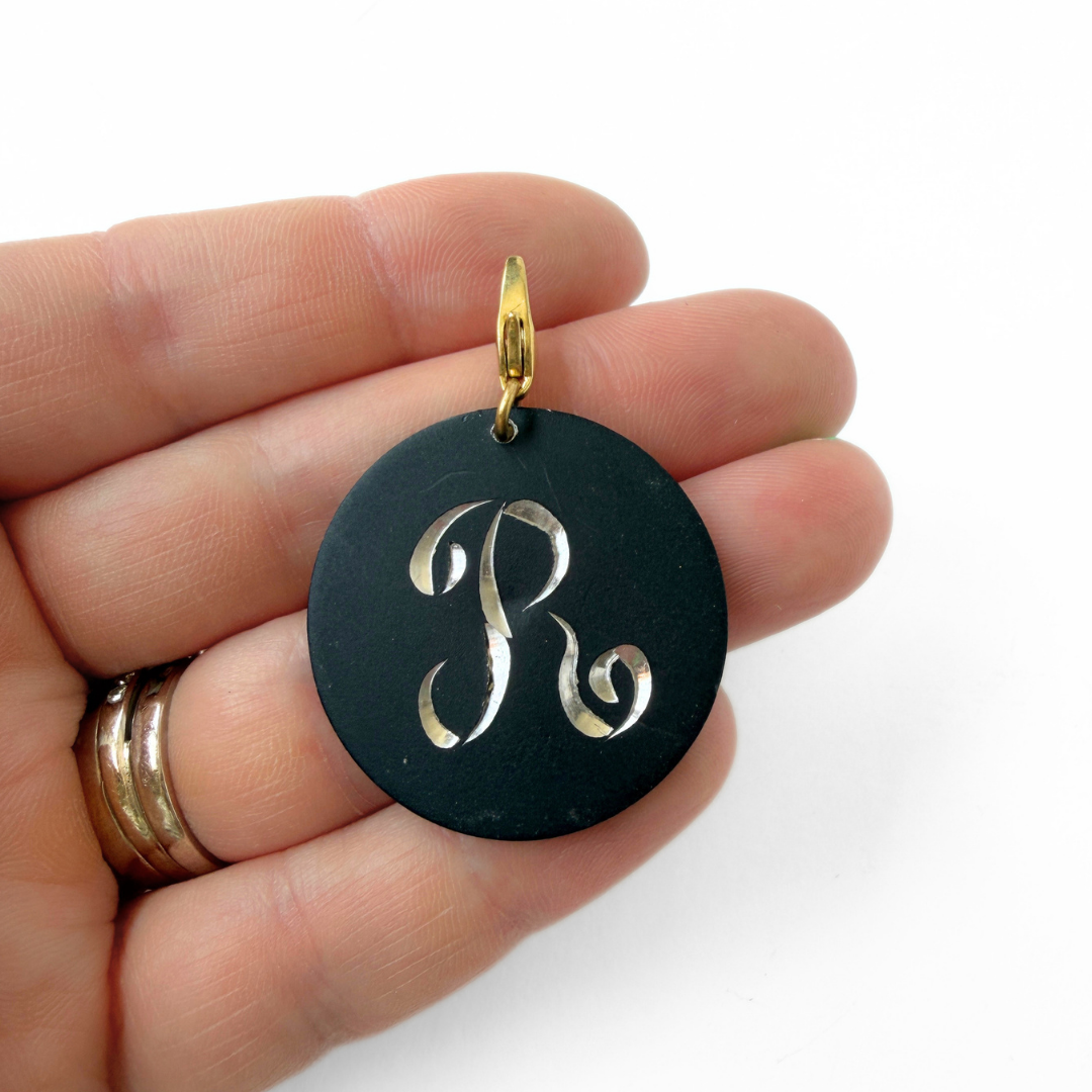 Large vintage black matte circular "R" monogram charm