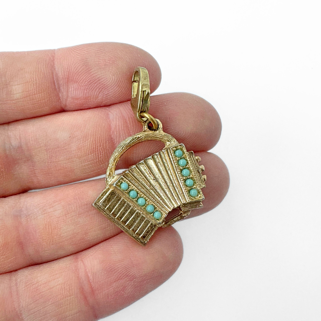 Vintage muted gold accordion charm with turquoise stones