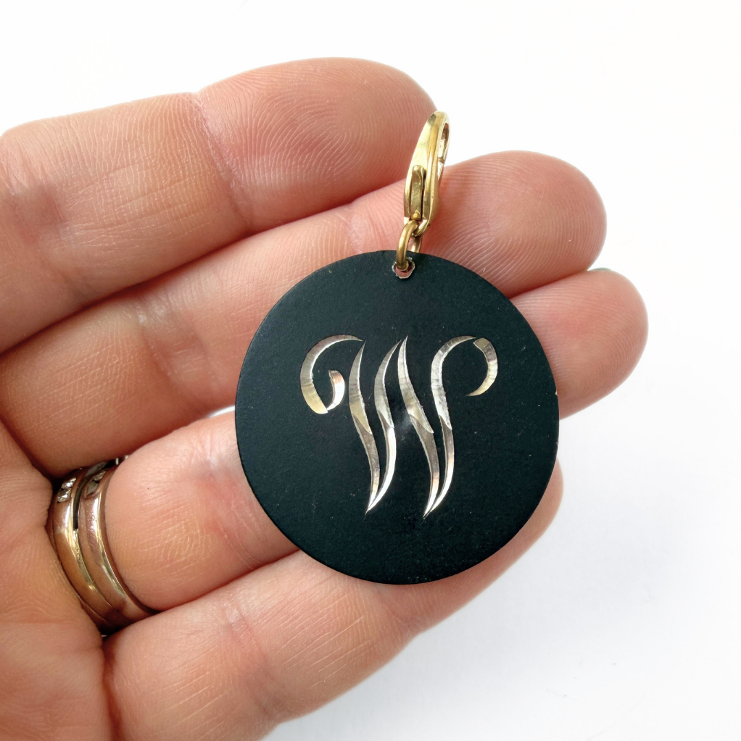 Large vintage black matte circular "W" monogram charm