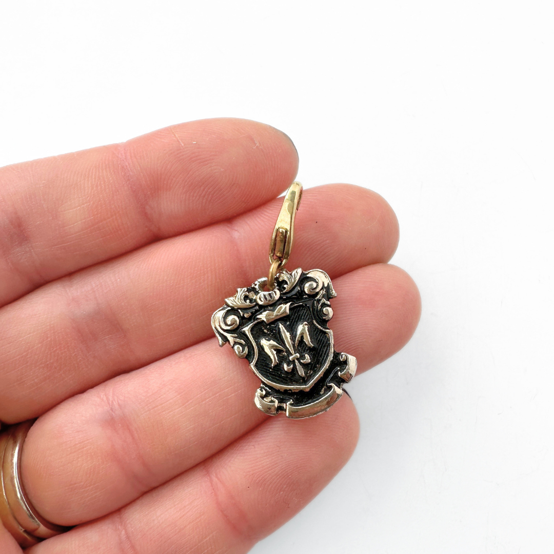 Vintage gold and black enamel fleur de lis shield charm