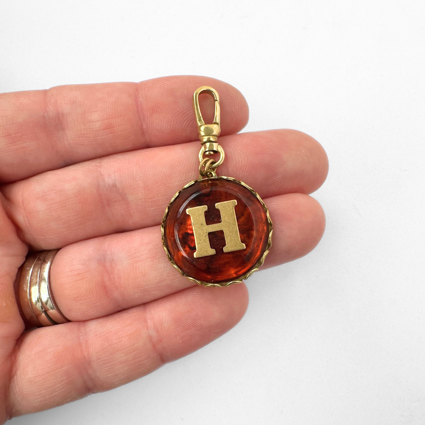 Vintage round tortoise shell and brass "H" charm