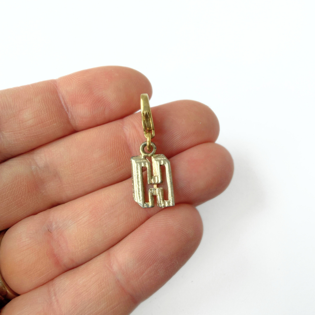 Small vintage gold tone cutout "H" monogram charm