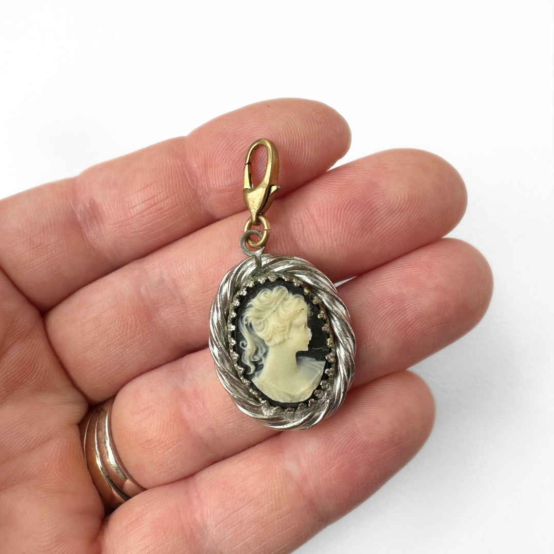 Vintage black and white cameo charm with silver setting and brass clasp