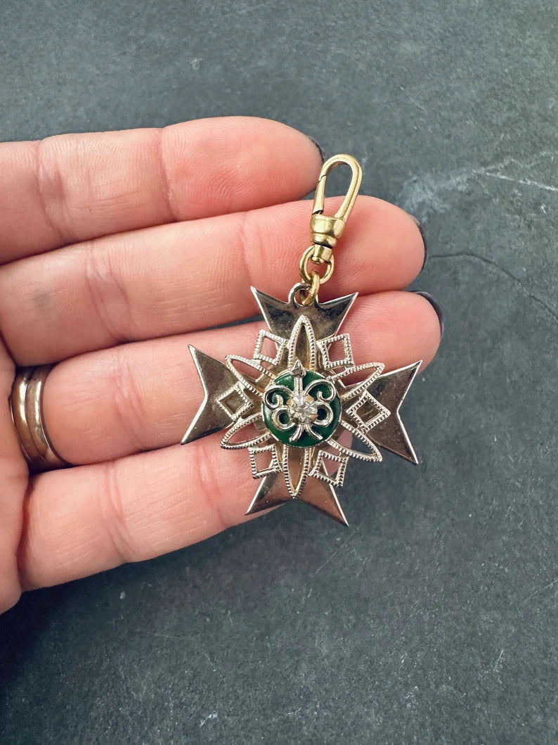 Vintage gold plated large crest with green enamel and rhinestone center