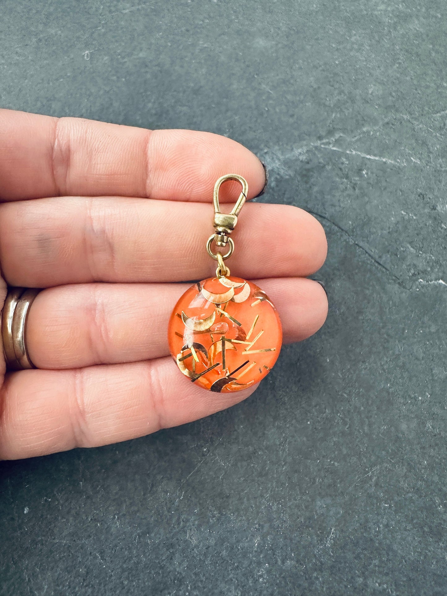Vintage orange and gold lucite confetti charm with raw brass swivel clasp