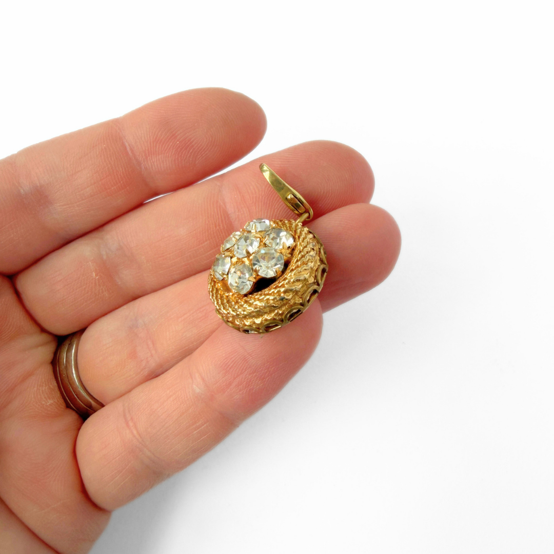 Vintage gold plated circular charm with rhinestone center