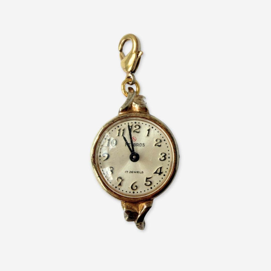 Vintage gold plated "Hilbros" circular watch face charm