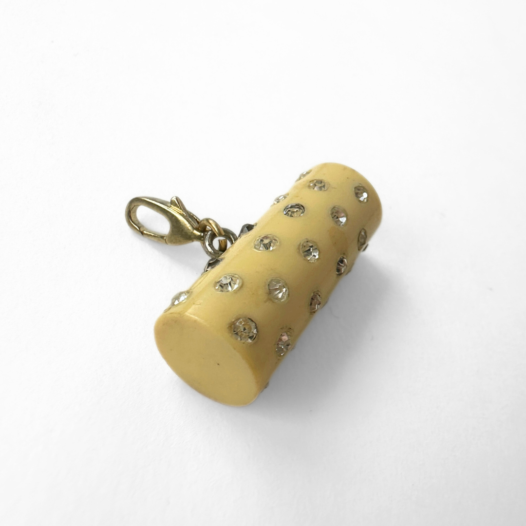 Vintage pale yellow rhinestone celluloid cylinder charm