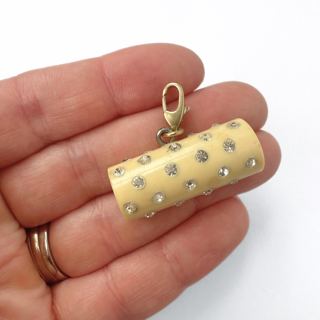 Vintage pale yellow rhinestone celluloid cylinder charm
