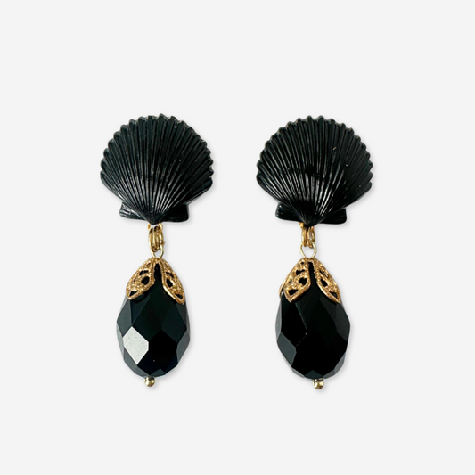 Black shell-shaped earrings with gold accents on a white background