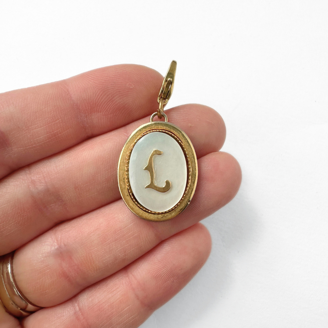 Vintage oval mother of pearl and gold "L" monogram charm