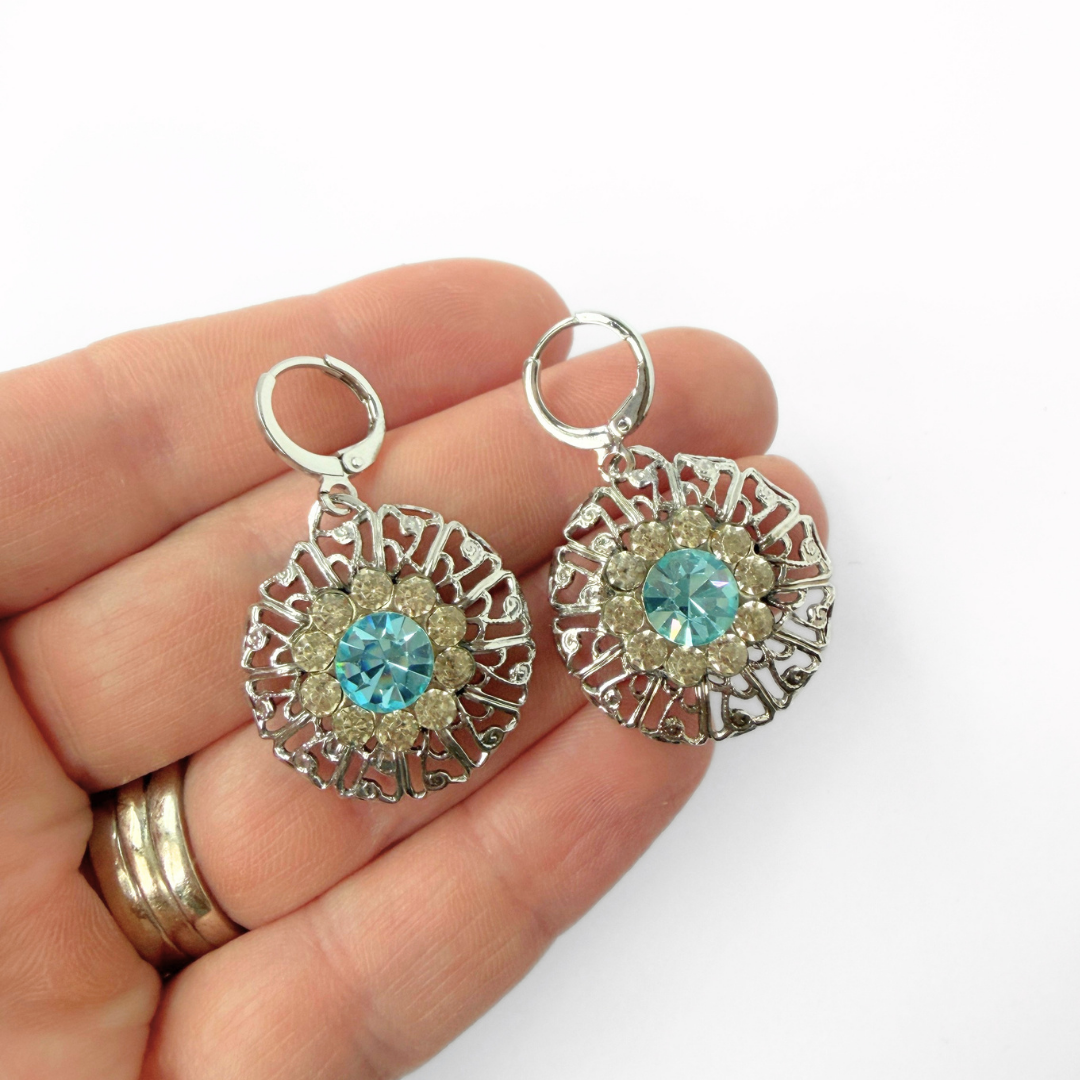 Refashioned vintage silver filigree earrings with aqua rhinestone center