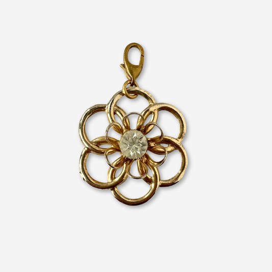 Vintage gold tone open flower charm with rhinestone center