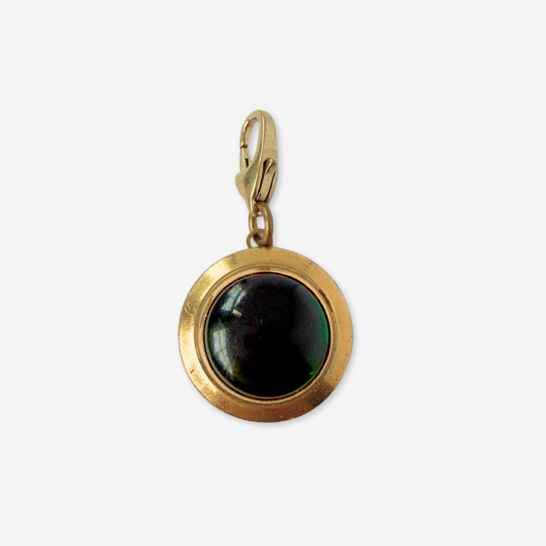 Vintage gold plated circular charm with green glass center