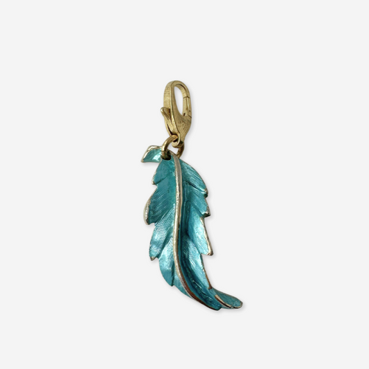 Teal feather pendant with gold chain on a white background