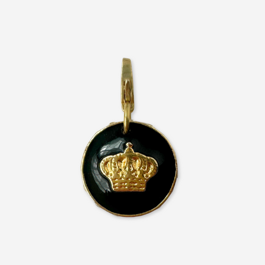 Gold and black pendant with a crown design on a white background