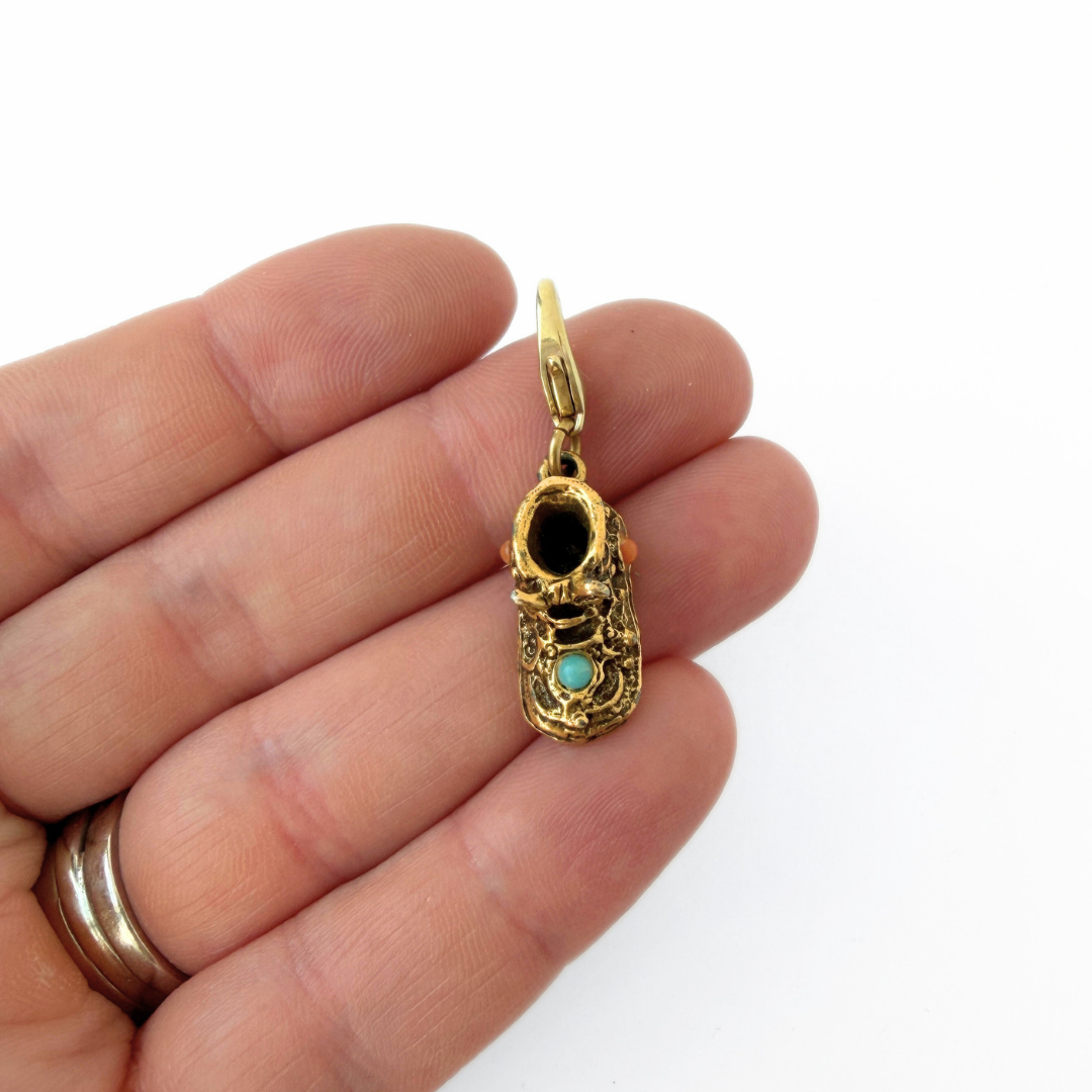 Vintage aged gold baby shoe charm with turquoise and coral stones