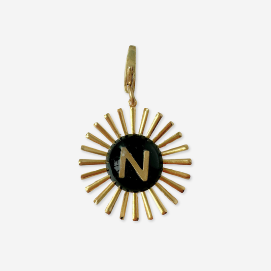 Vintage black glass "N" monogram sunburst charm